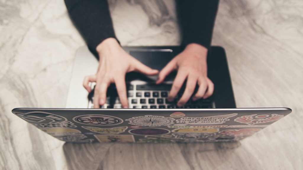 Person writing email on laptop